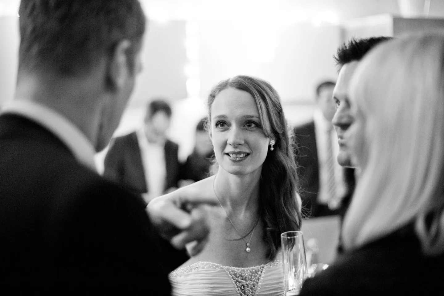 Bride with guests at wedding reception, black and white