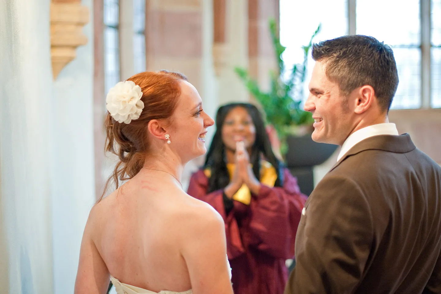 Bride and groom smiling during the wedding ceremony.