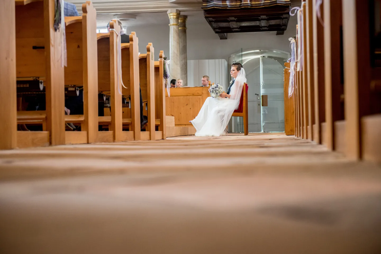 Bride sitting in the church, side view