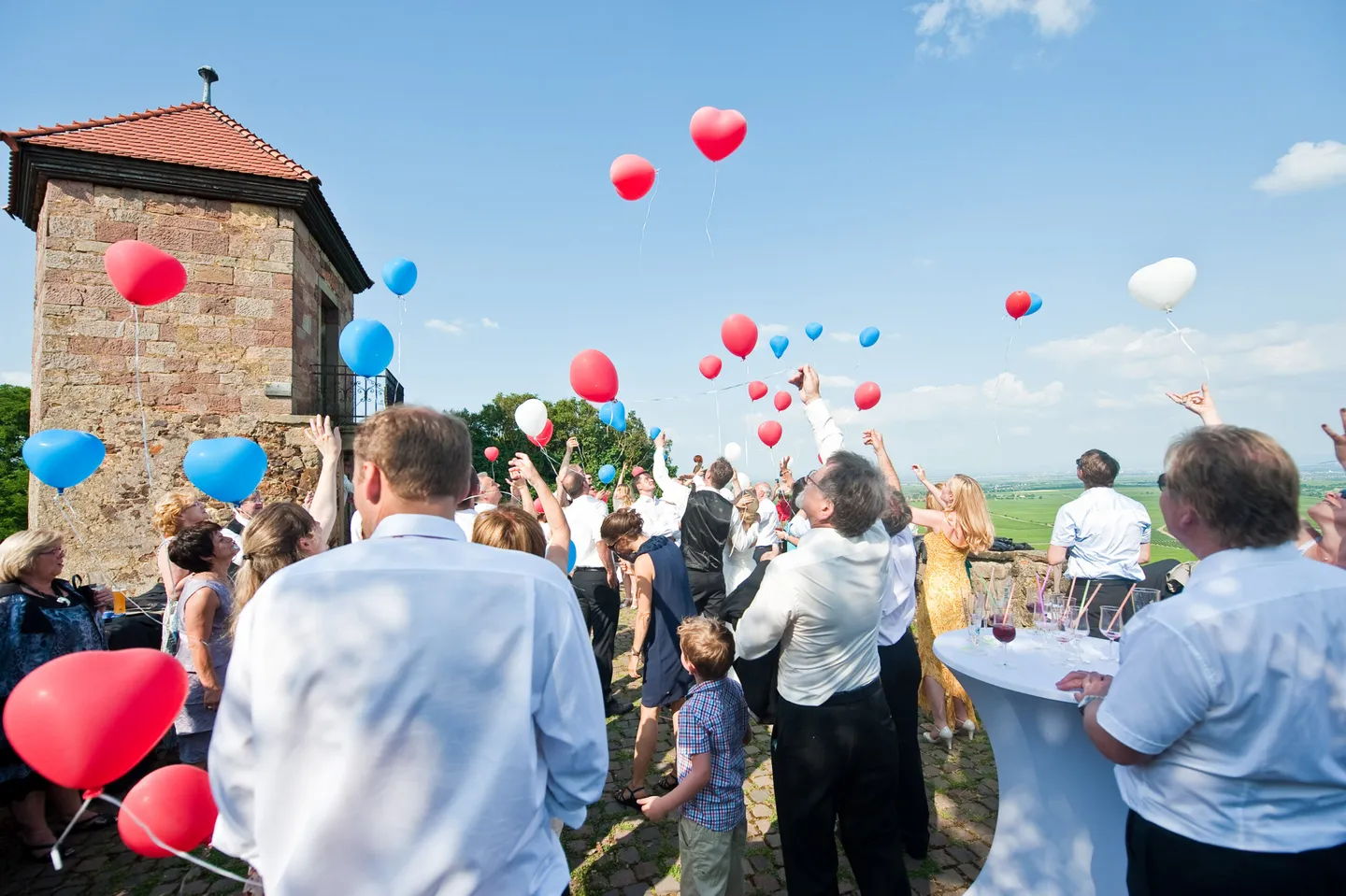People release colorful balloons into the air.