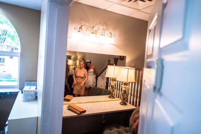 Guests in an elegant room with mirrors.