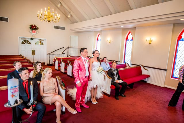 Wedding couple in chapel with guests