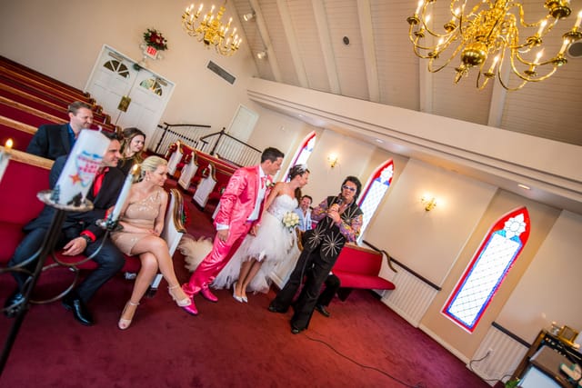 Wedding couple with entertainer in a chapel