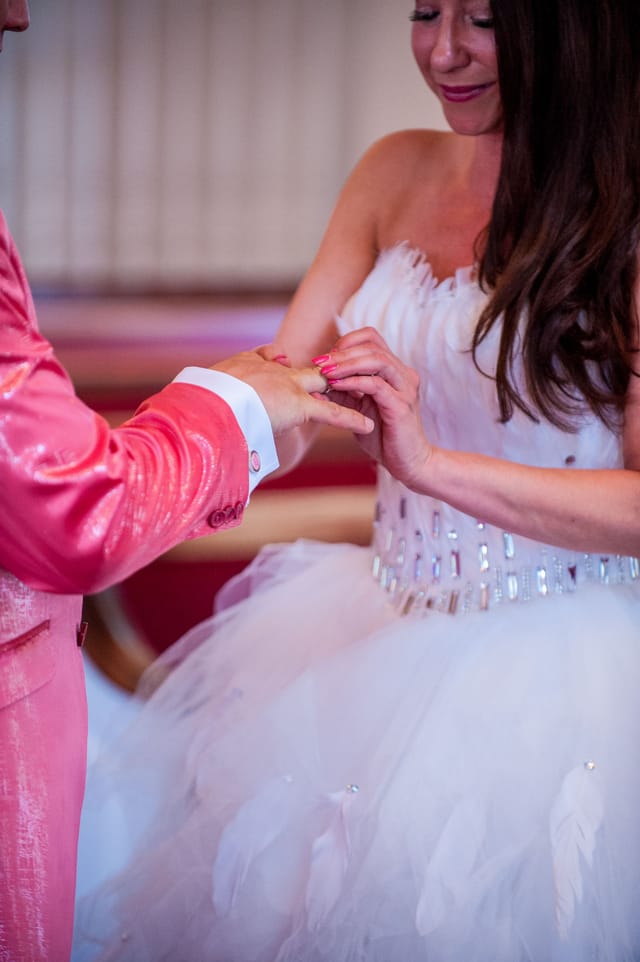 Bride and groom exchange rings at wedding