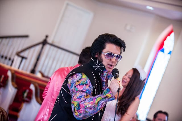 Person in colorful shirt sings with microphone