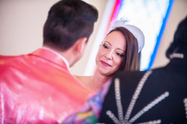 Woman in festive dress smiles at wedding