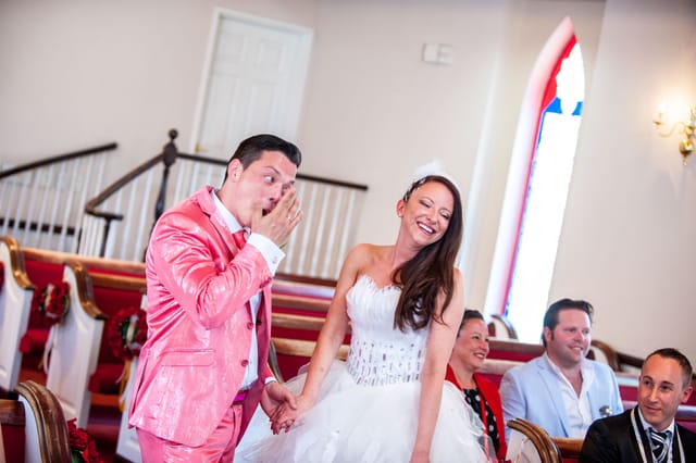 Joyful wedding couple smiling in church