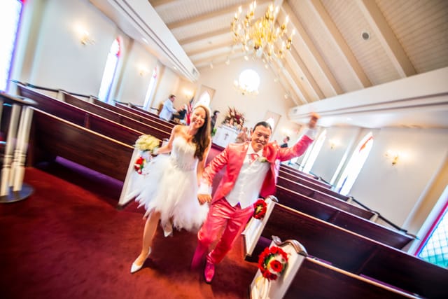 Laughing bridal couple in chapel during wedding