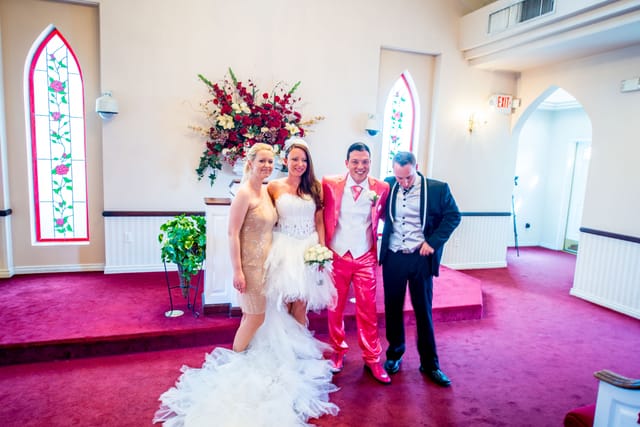 Four people at a wedding in a chapel
