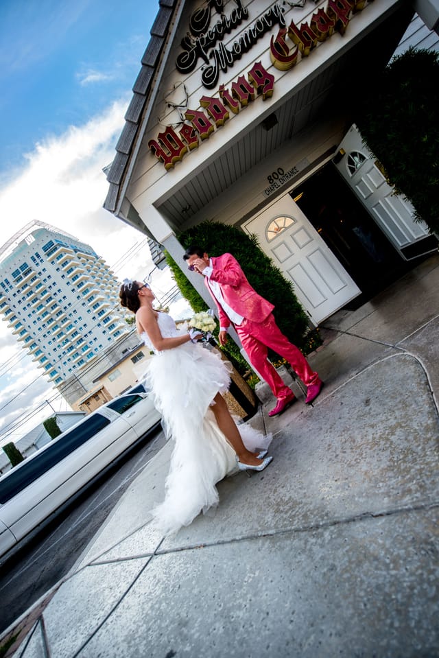 Couple in front of wedding chapel in wedding dress