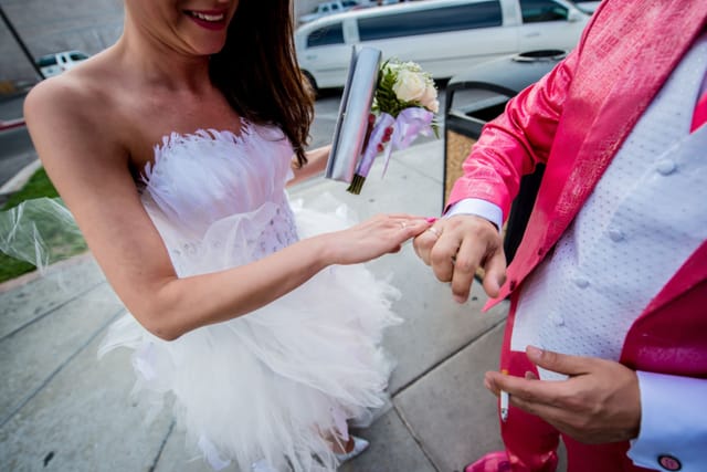 Bride and groom exchange wedding rings