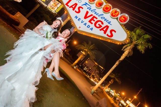 Wedding couple in front of Las Vegas sign