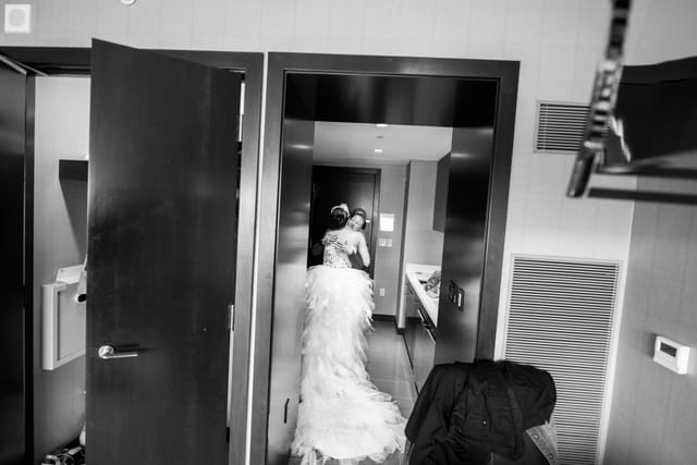 Bride hugs companion in the hallway
