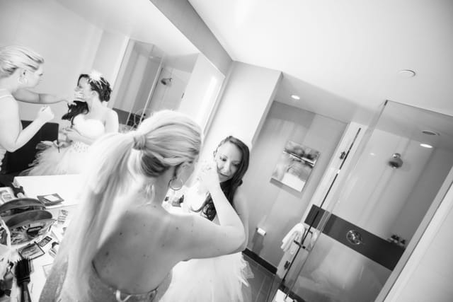 Women applying bridal make-up in the bathroom
