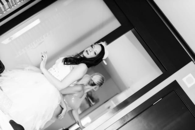 Two women in elegant dresses in the interior.