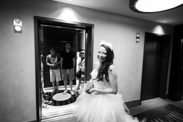 Smiling woman in front of an open elevator